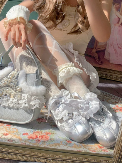 Silver high-heeled shoes with ruffled details on a floral surface