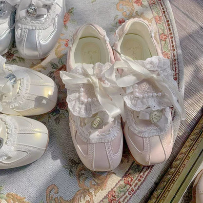 Pink sneakers with lace details on a floral fabric background