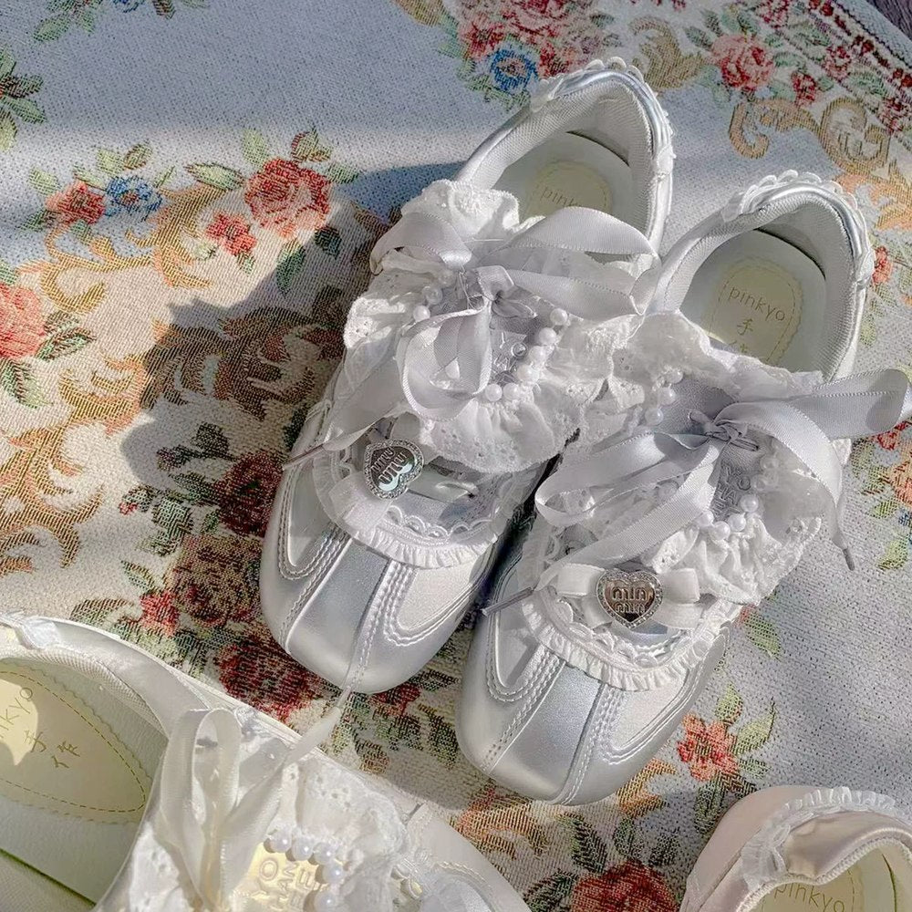 White lace-up shoes on a floral fabric background