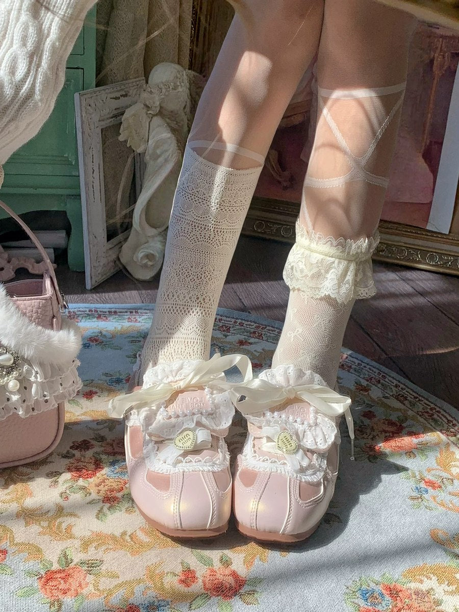 Vintage-style shoes with lace details worn with white knee-high socks in a decorative setting.