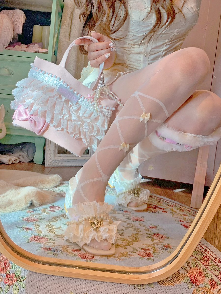 Person wearing white lace stockings and holding a decorative bag in a room with floral rug and wooden furniture.