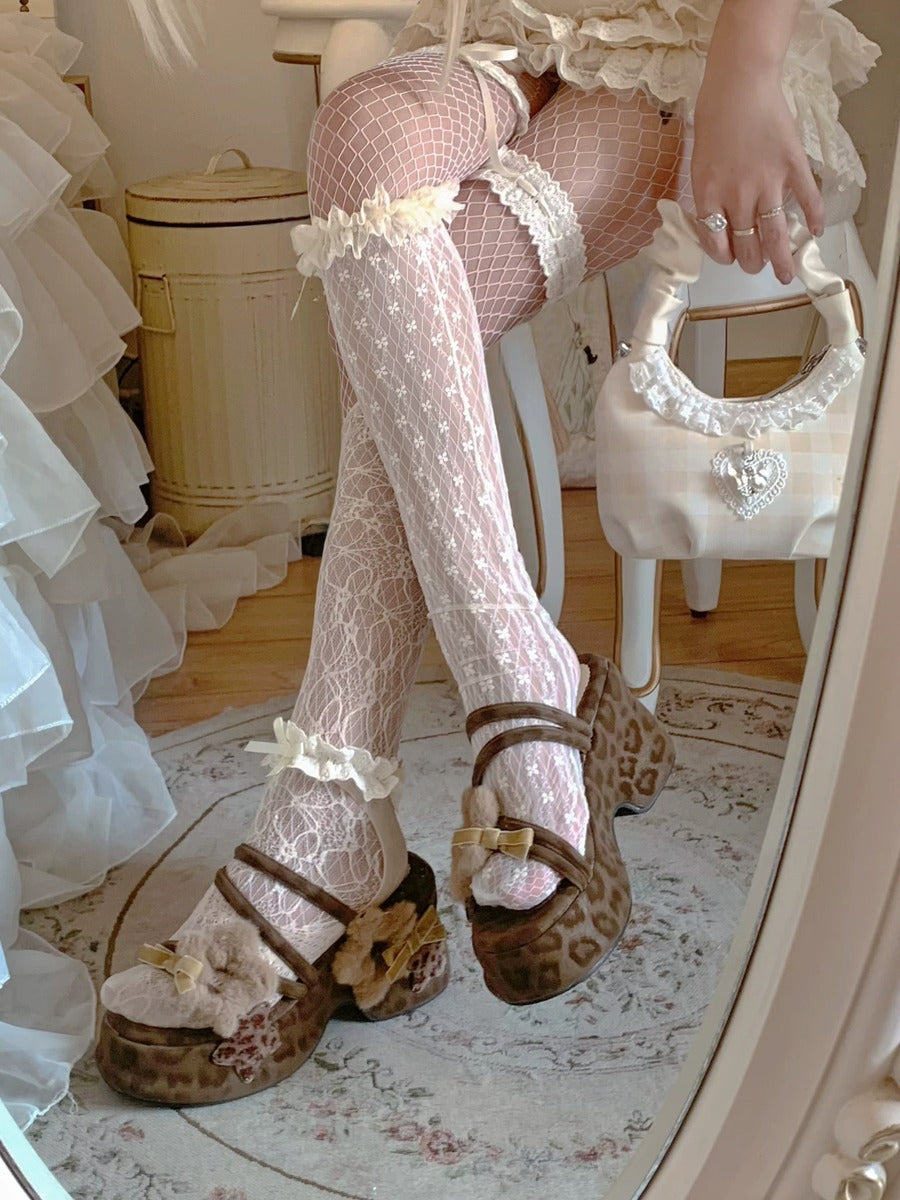 Person wearing fishnet stockings with lace trim and leopard print brown shoes in a room.