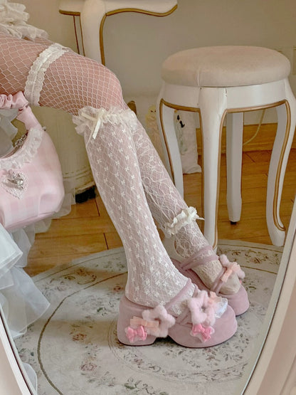 Person wearing pink floral slippers and fishnet stockings in a room with a mirror.