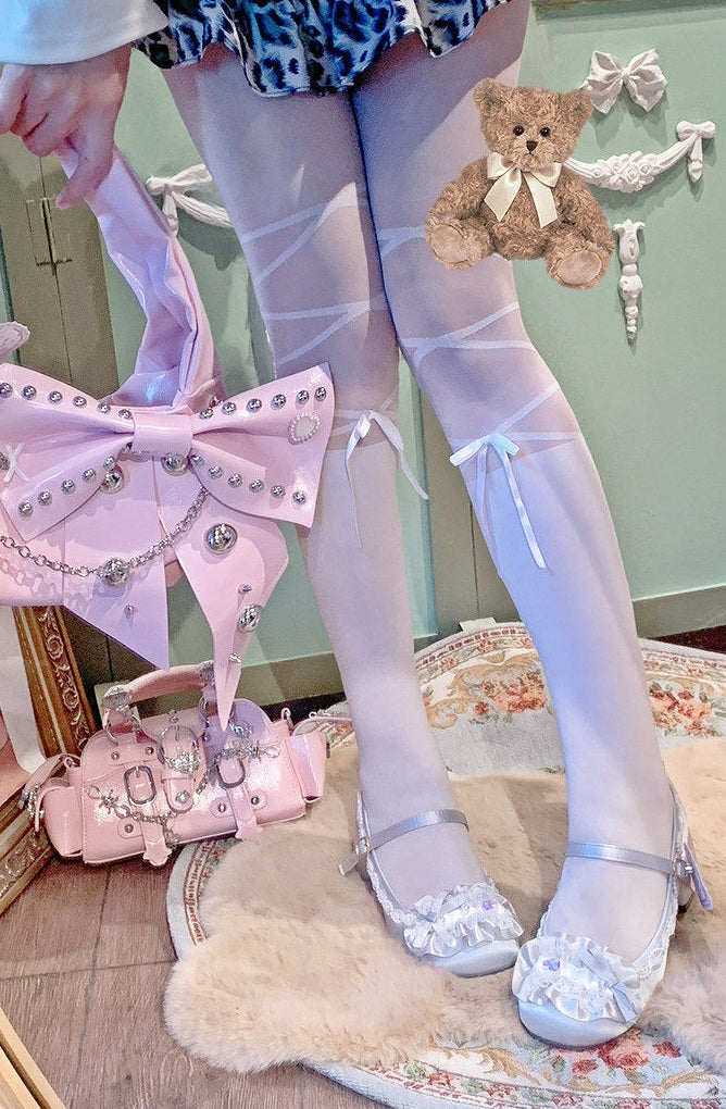 Person wearing white tights with decorative elements, holding a pink bag with bow details.