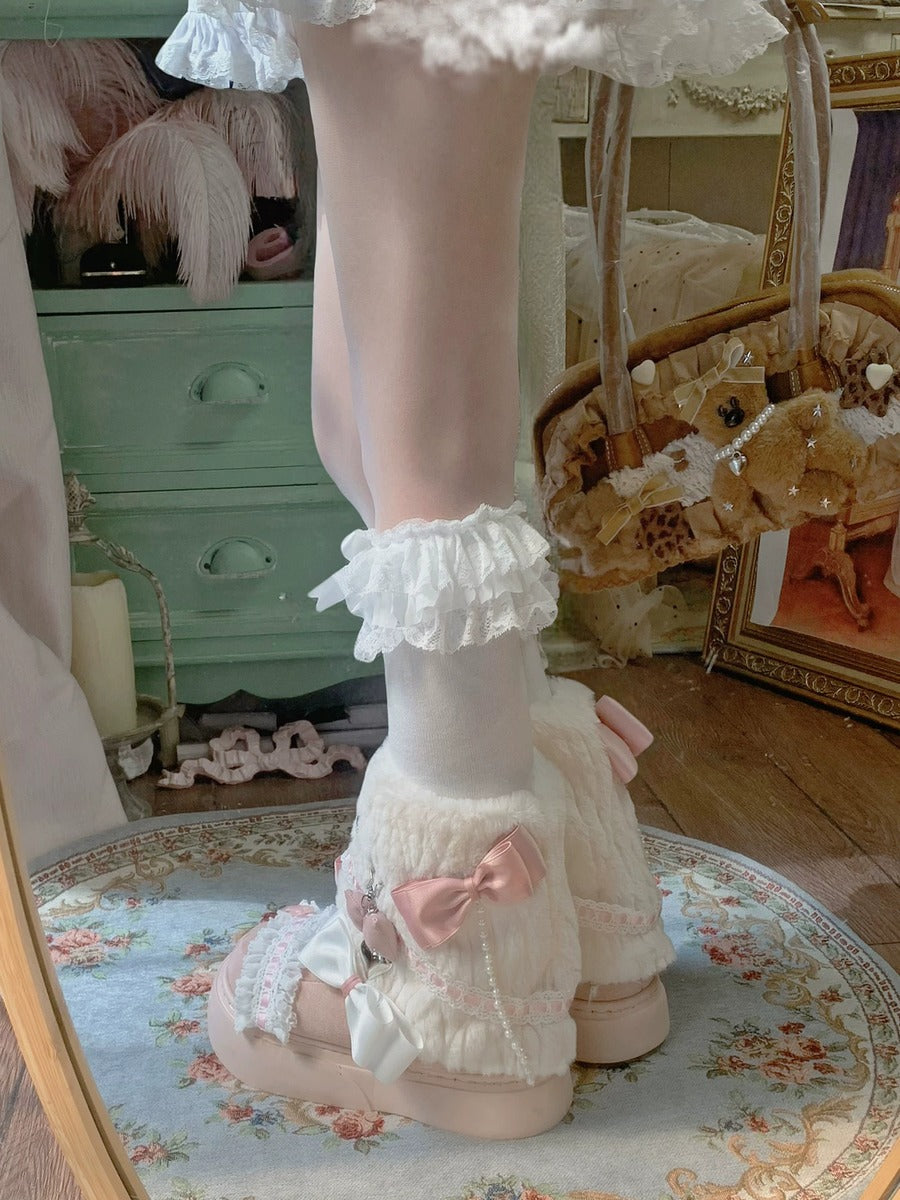 Pastel-colored outfit with ruffled elements on a floral rug.