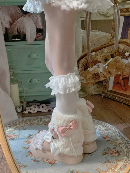 Pastel-colored outfit with ruffled elements on a floral rug.