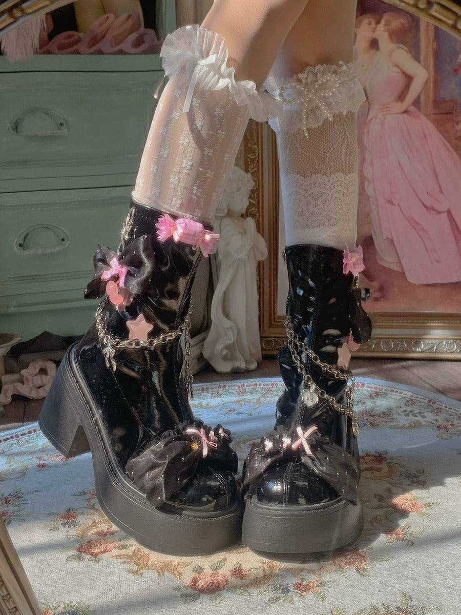 Black platform boots with floral decorations worn by a person in a vintage setting.