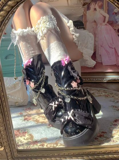 Decorative black shoes with chains and flowers worn with white stockings in a vintage setting.