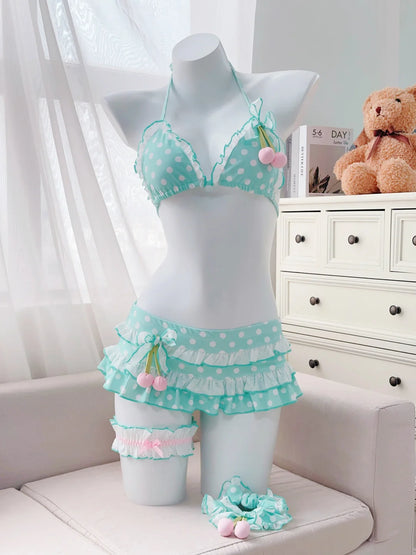Mannequin wearing a turquoise polka dot lingerie set with ruffles in a room setting.