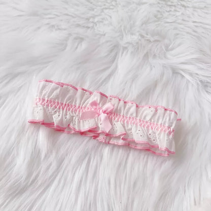 Pink lace headband on a white fluffy surface