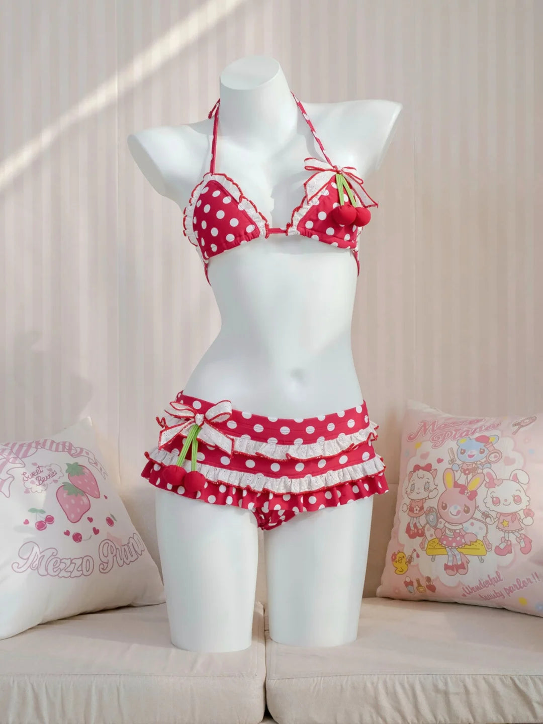 Red polka dot bikini set on a mannequin against a light background