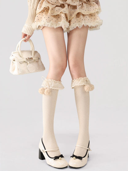 Person wearing a matching outfit with a skirt, sweater, knee-high socks, and shoes on a white background.