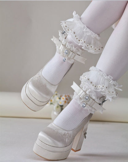 White platform shoes with lace details on a neutral background