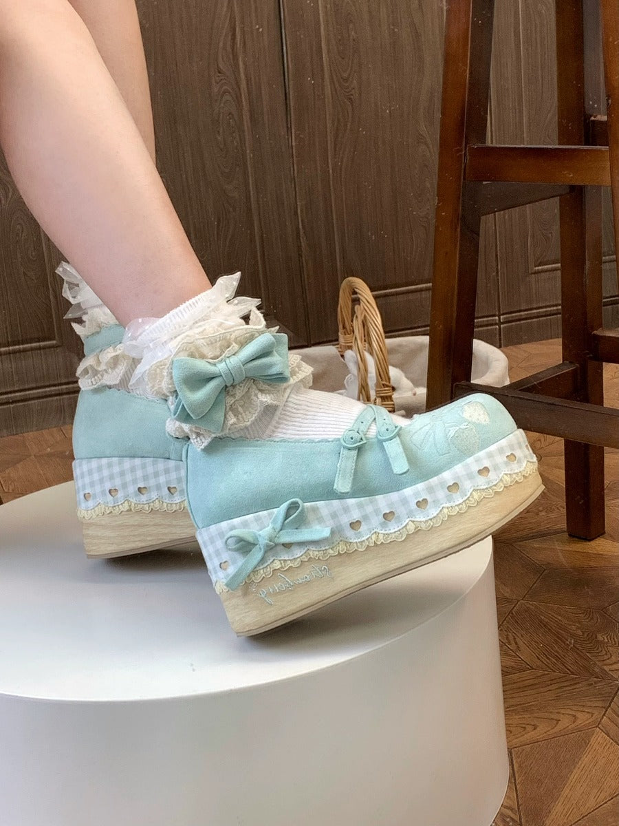 Pair of Cottagecore light blue shoes with lace details on a white surface.