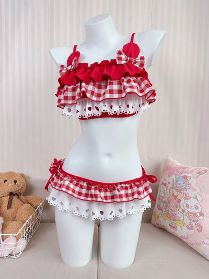 Red and white checkered outfit on a mannequin with a teddy bear and pillow in the background.