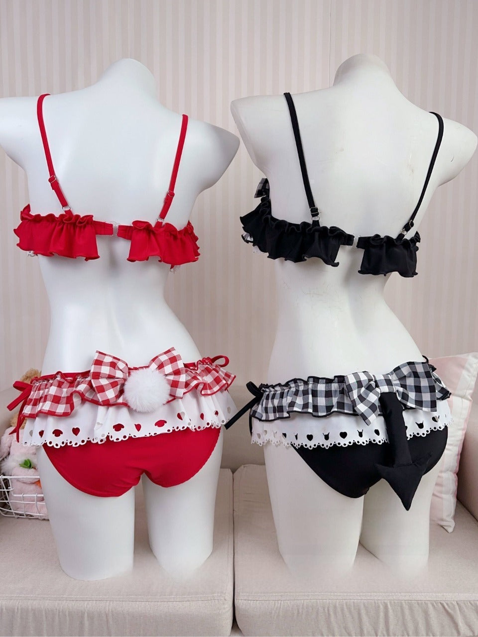 Red and black lingerie sets on mannequins against a neutral background