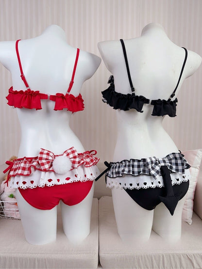 Red and black lingerie sets on mannequins against a neutral background
