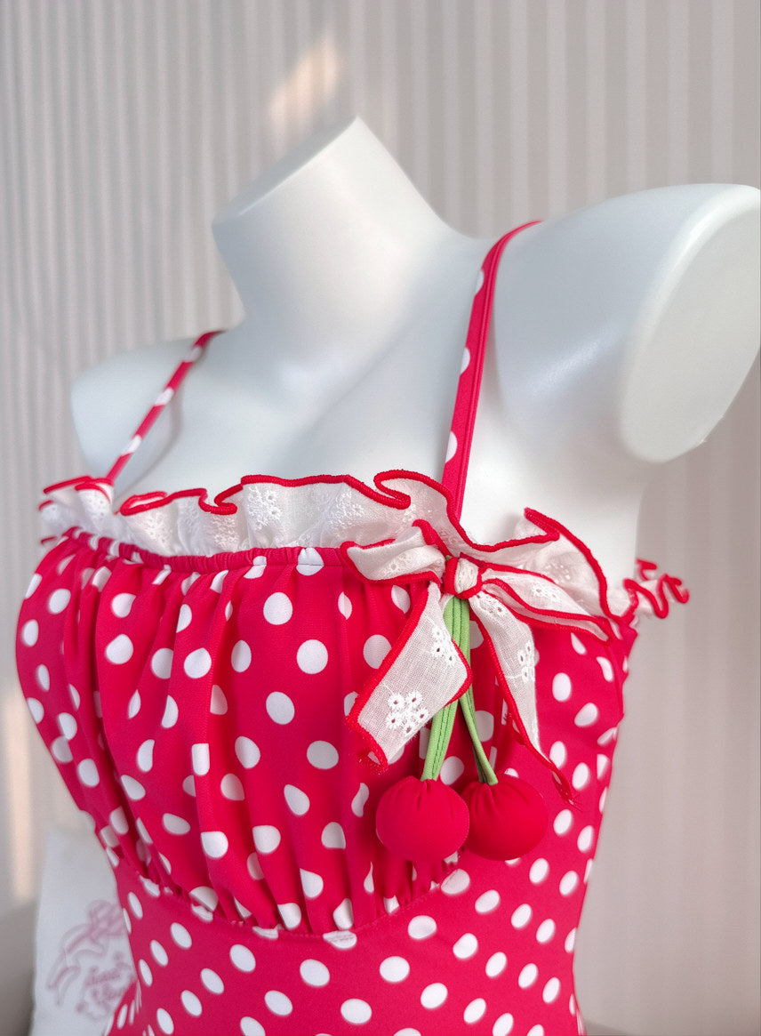 Red polka dot dress with white trim on a mannequin against a neutral background