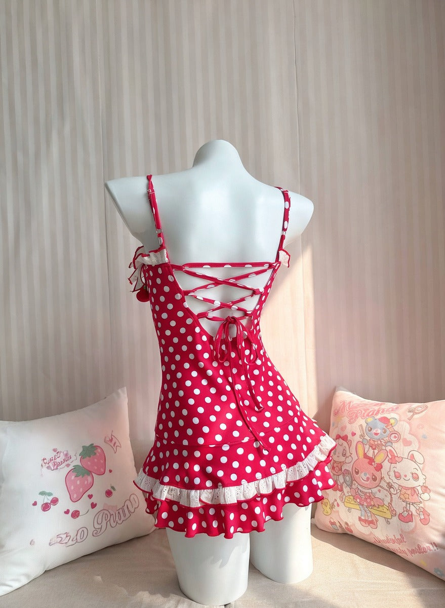 Red polka dot dress on a mannequin against a neutral background