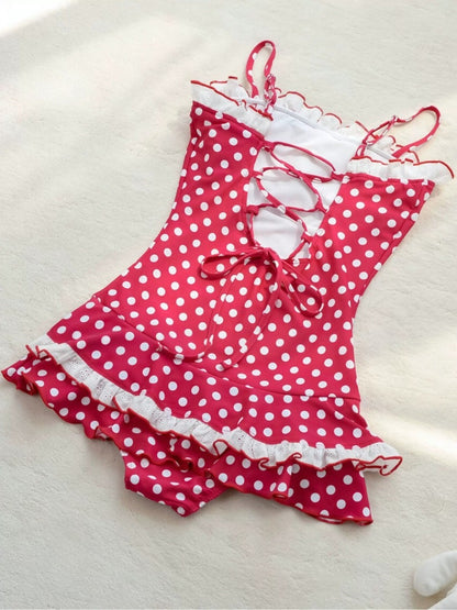 Pink polka dot swimsuit with ruffles on a white background