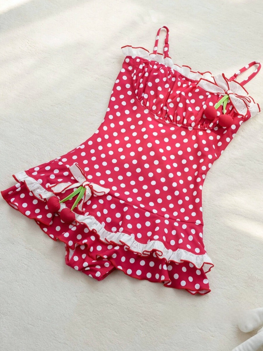 Red polka dot swimsuit with cherry details on a white surface