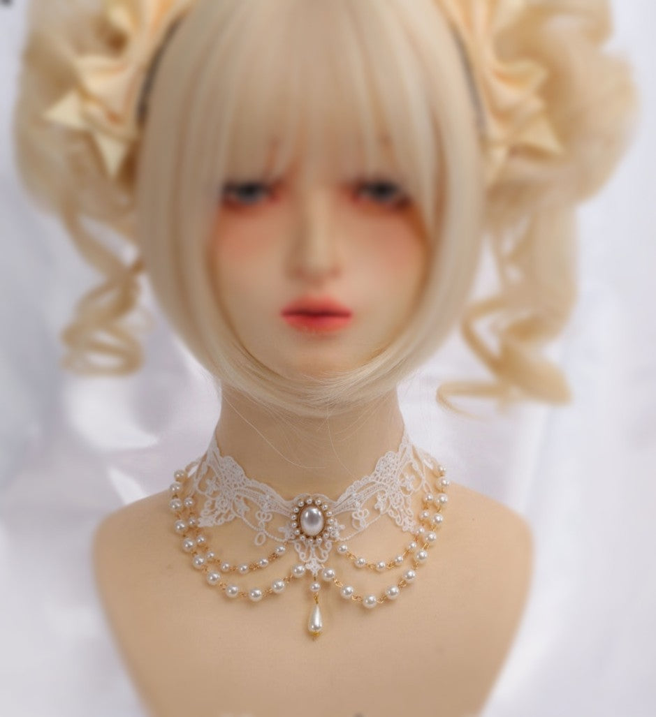 Mannequin head with blonde wig and decorative necklace on a white background