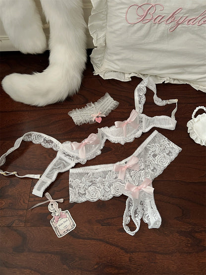 Lace babydoll set with ribbons on a wooden surface, featuring the brand 'Babydolls'.