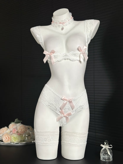 White lace lingerie set on a mannequin against a black background