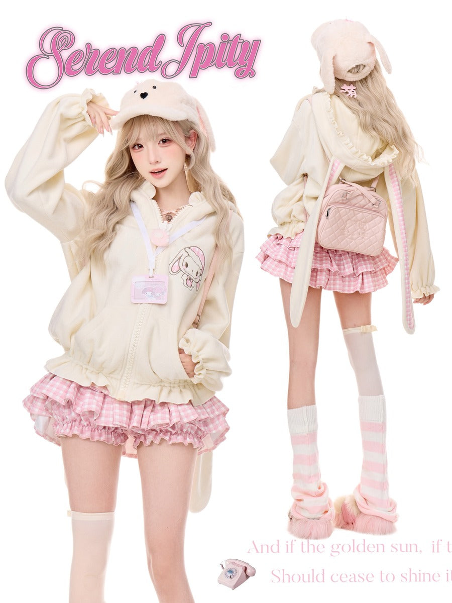 A fashion collage showing a model in two views wearing a pastel bunny-themed outfit. The outfit includes a cream-colored bunny hooded jacket with a rabbit graphic, a pink and white gingham pleated mini skirt, pink-and-white striped knee-high socks, and a matching pink backpack.