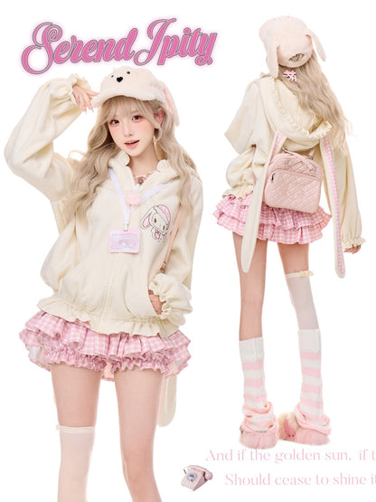 A fashion collage showing a model in two views wearing a pastel bunny-themed outfit. The outfit includes a cream-colored bunny hooded jacket with a rabbit graphic, a pink and white gingham pleated mini skirt, pink-and-white striped knee-high socks, and a matching pink backpack.