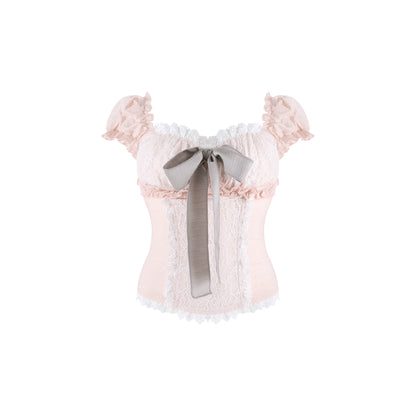 A pale pink lace corset-style top with ruffled off-the-shoulder sleeves, a large gray ribbon bow at the center front, and white lace trim along the neckline and hem, shown on a plain white background.