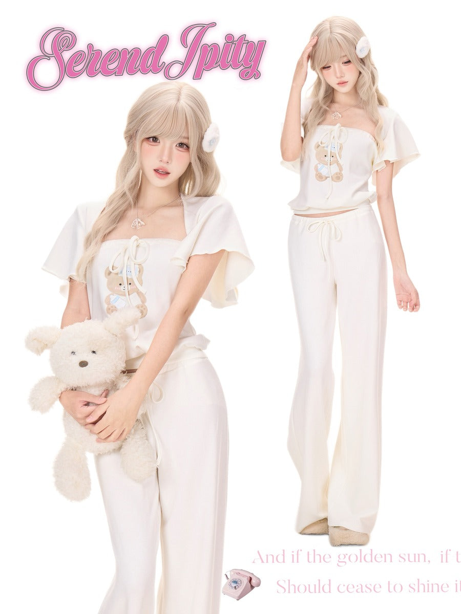 A fashion listing image showing a blonde model in a cream and white two-piece outfit with a teddy bear, alongside a smaller back view of the same outfit.