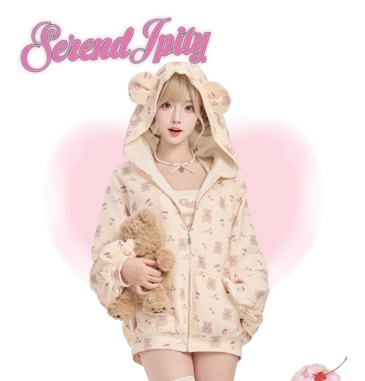 Person wearing a cute outfit with a hood and bear ears, holding a plush toy, on a white background.