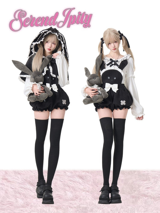 Two people in black and white outfits with bunny plush toys on a pink background