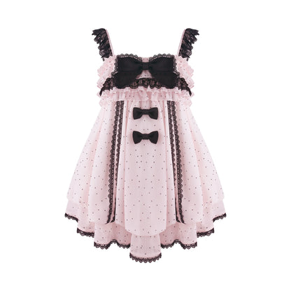 A pink Lolita-style dress with black lace trim, polka dots, ruffles, and three black bow accents on the bodice and skirt, shown against a plain white background.