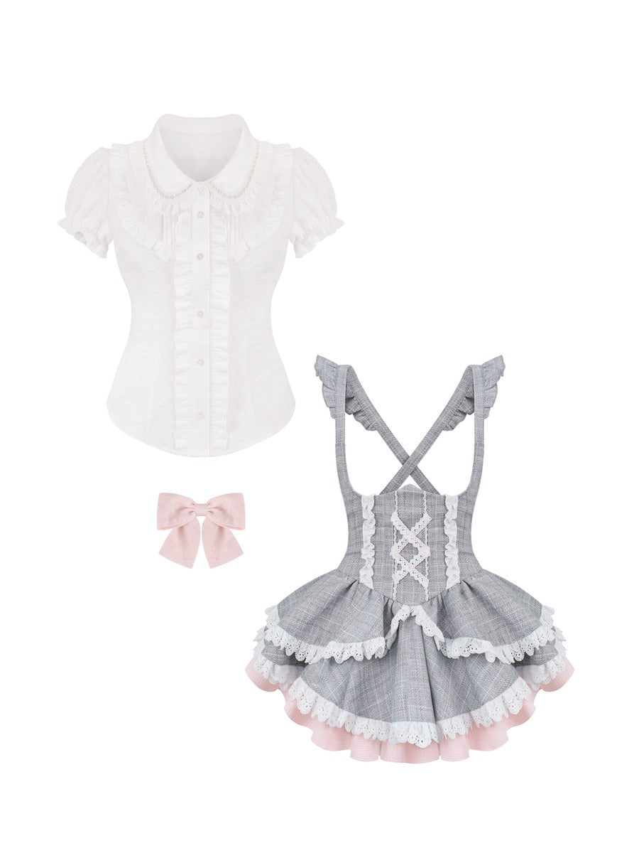 White blouse with ruffled collar, gray checkered apron with lace details, and pink bow on a white background