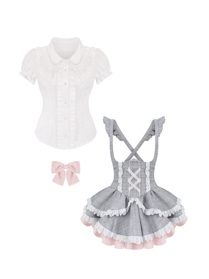White blouse with ruffled collar, gray checkered apron with lace details, and pink bow on a white background