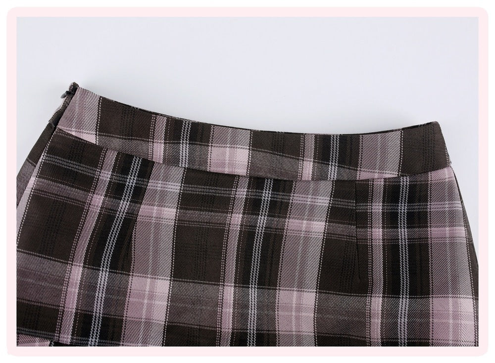 A close-up of a plaid skirt in dark brown, black, and dusty pink, showing the waistband and fabric texture against a light gray background.