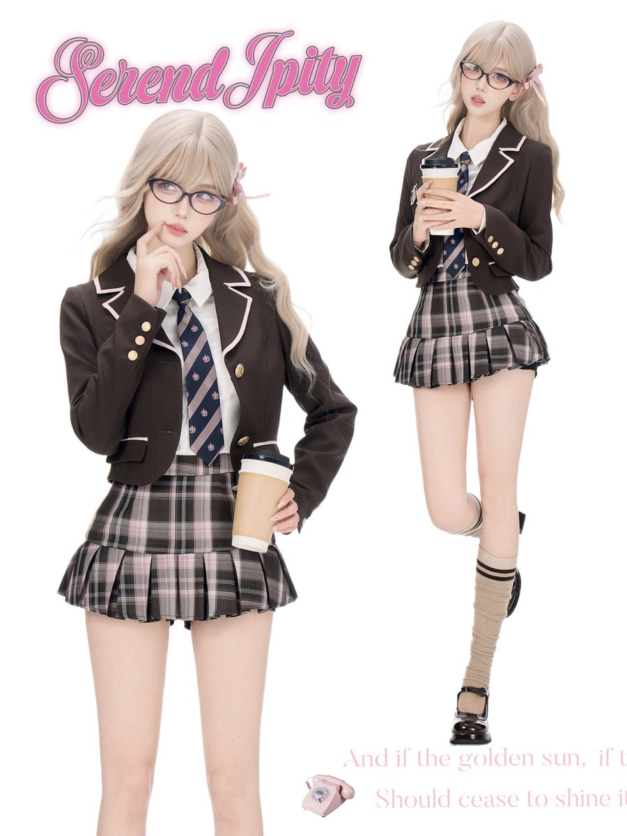 A fashion collage showing a model in two poses wearing a dark brown blazer, a white shirt, a blue patterned tie, and a plaid pleated mini skirt. The 'Serendipity' is written in pink script at the top left, and a quote is printed at the bottom right on a white background.