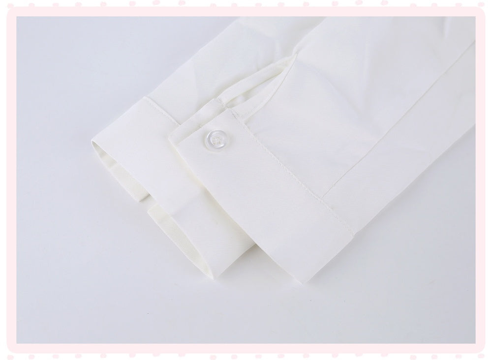 A close-up of a white long-sleeve dress shirt cuff with a single button closure, shown on a light gray background with a decorative pink border.