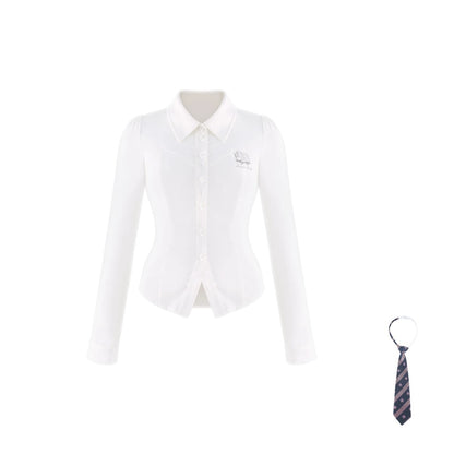 A white long-sleeve button-front collared blouse with a small embroidered chest logo, shown on a plain white background with a small striped necktie accessory at the lower right.