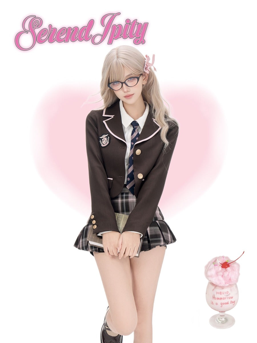 A young woman with long blonde hair and glasses poses in a school uniform consisting of a dark brown blazer, white shirt, striped tie, and plaid pleated skirt. The image has a pink heart-shaped glow behind her, the text 'Serendipity' at the top left, and a small pink drink illustration at the bottom right.