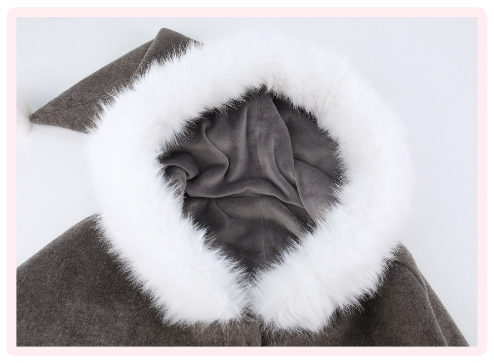 Close-up of a dark brown coat or dress with a large white faux-fur trimmed collar and a gray fabric lining visible inside the opening.
