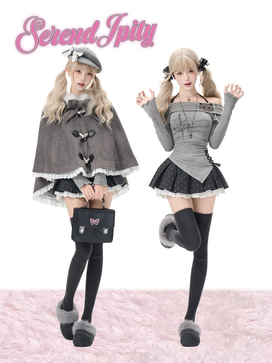 Two models showcase gothic Lolita fashion outfits from on a white background with a pink faux fur floor. The left model wears a gray cape with black buttons, a black and white frilly skirt, and holds a black handbag.