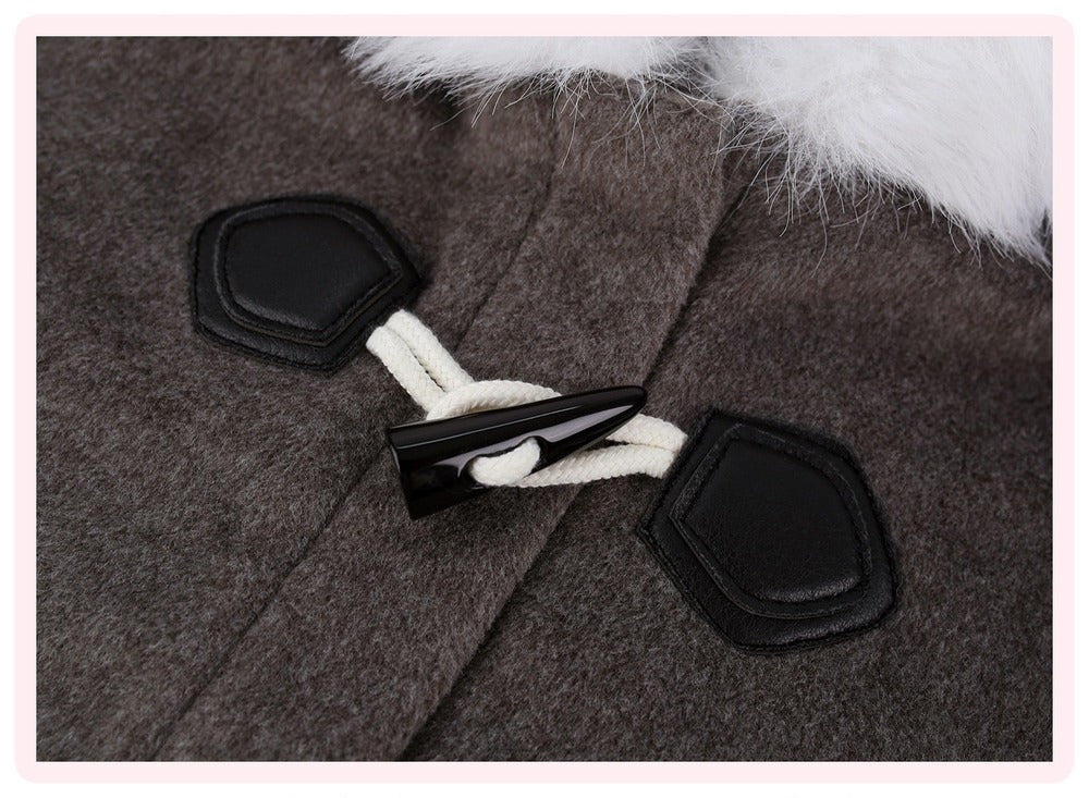 Close-up of a dark brown wool-like coat with black toggle closures, white rope, and a white faux-fur trim at the collar.