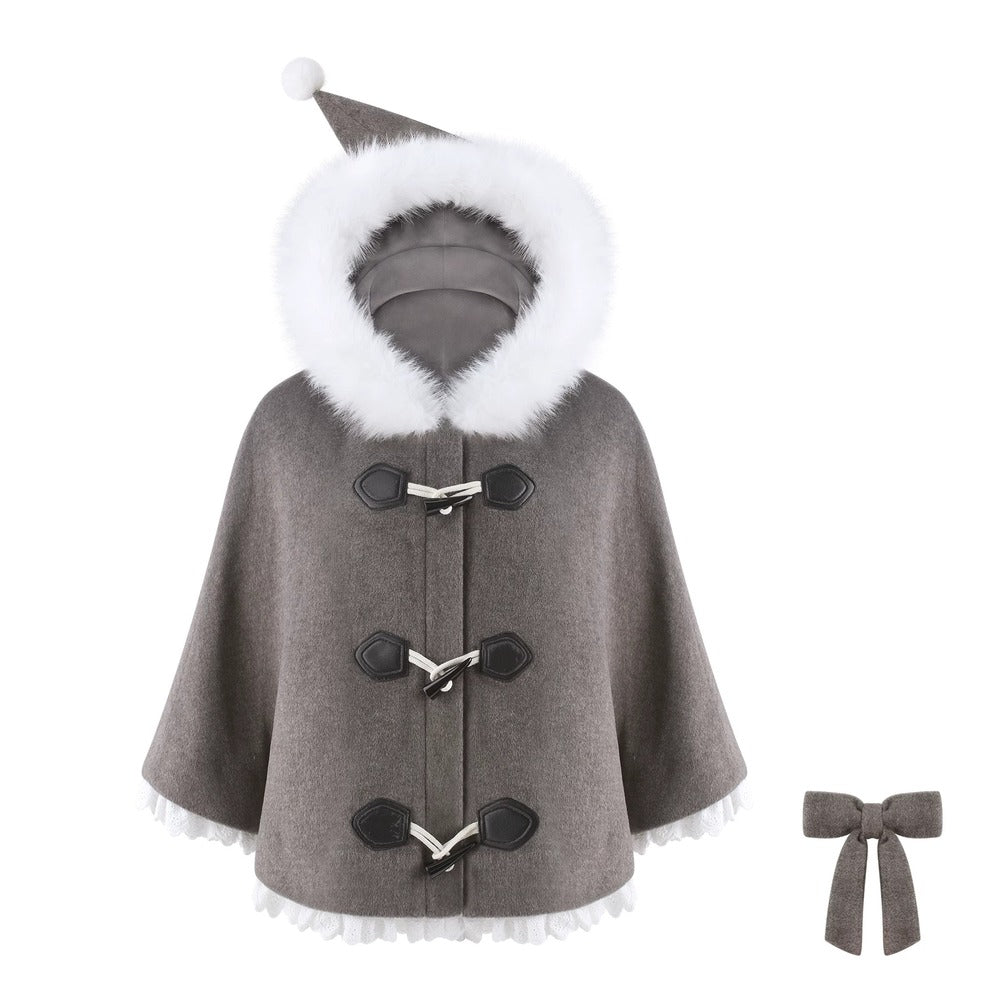 A gray cape coat with a white faux-fur trimmed hood and hem, black toggle closures, and a matching gray bow accessory shown beside it on a white background.