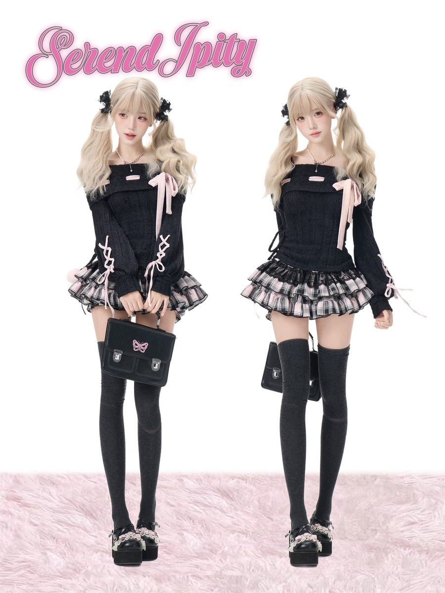 Two doll-like models wearing matching black gothic Lolita outfits with pleated mini skirts, long sleeves, lace-up details, thigh-high stockings, and black handbags, shown on a white background with a pink furry surface and the text 'Serendipity' at the top.