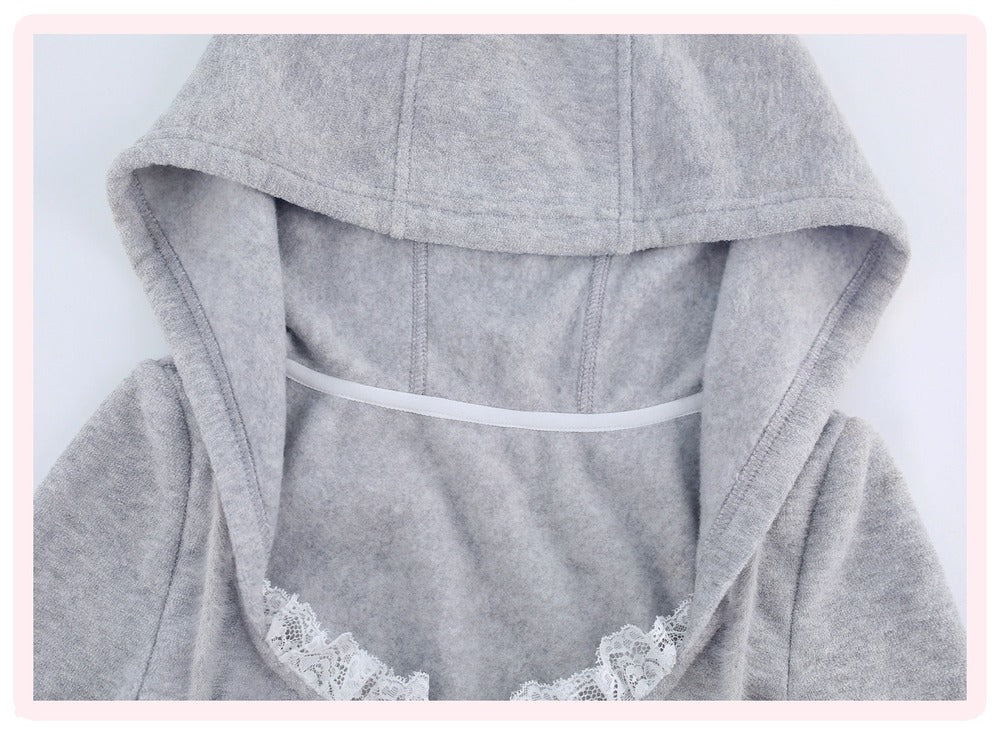 Close-up of a light gray hooded sweatshirt with a white lace trim along the neckline and a white elastic band inside the hood.