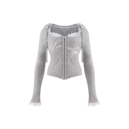 A light gray cropped zip-up hoodie with long sleeves, ruffled trim at the neckline and cuffs, and white script text on the front, shown against a plain white background.