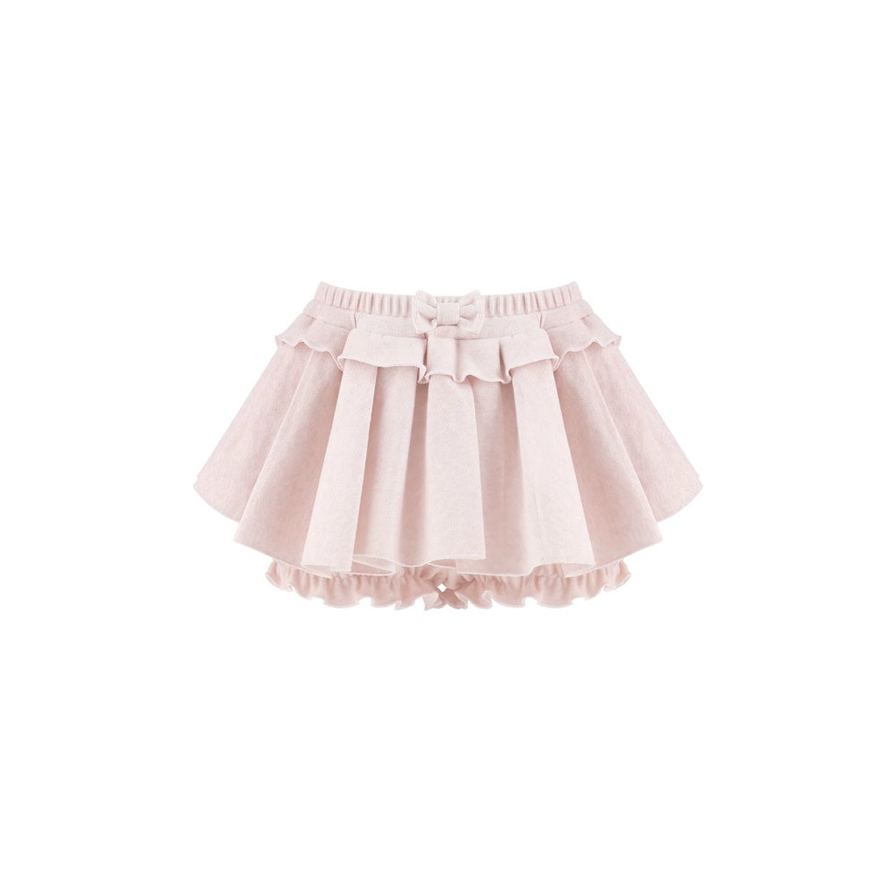 A light pink tiered ruffle skirt with a matching fabric bow at the center waist, displayed against a solid white background.